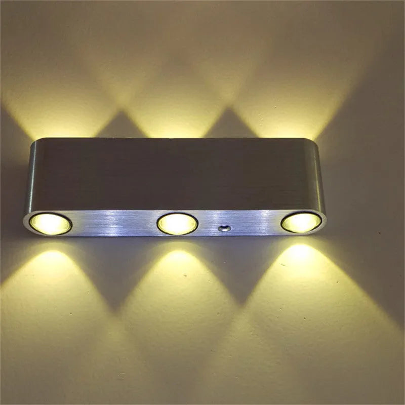 Silver aluminium rectangular LED wall lamp mounted on a wall displaying multiple colour options