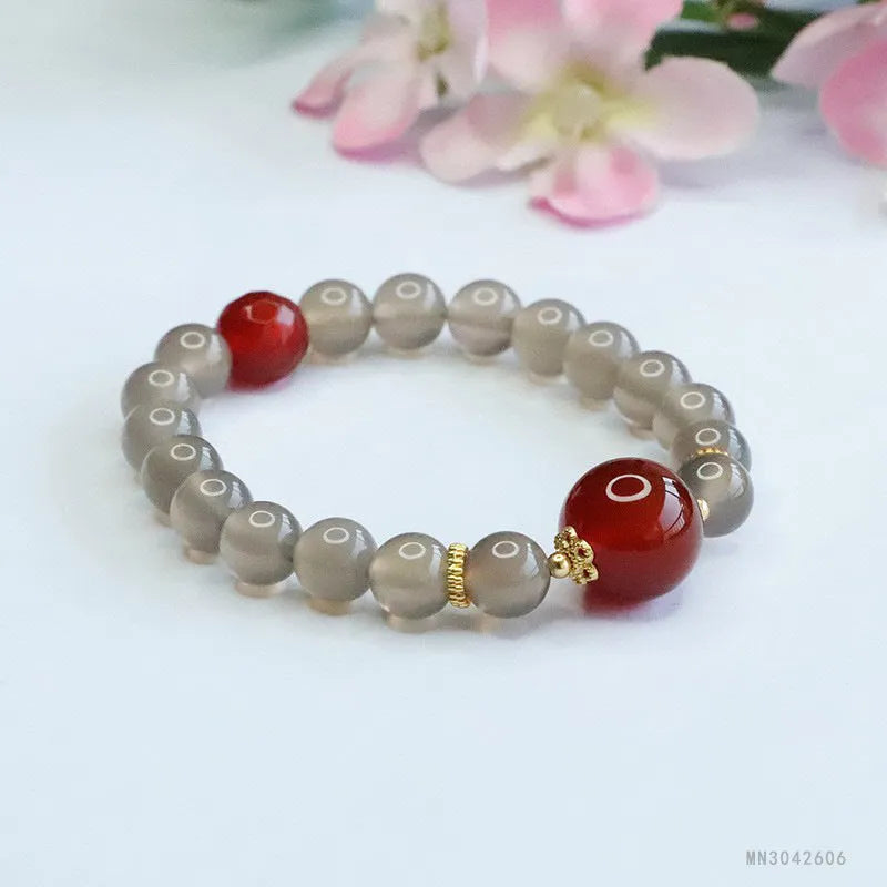 Smoky purple chalcedony red agate bracelet with 8mm geometric beads on a wrist.