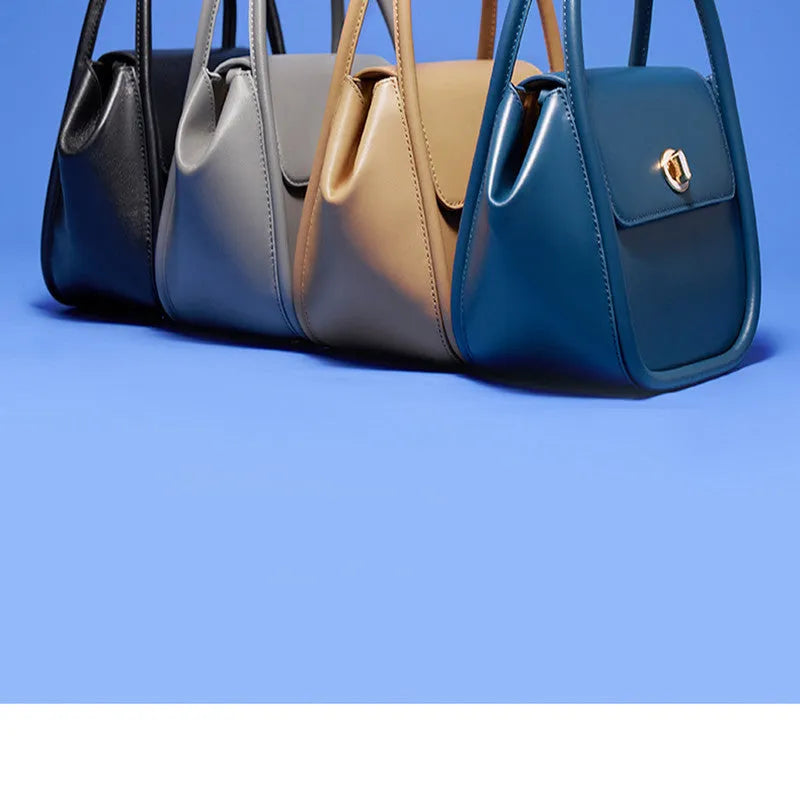 Women's leather wing tote bag in cow leather with a cross-body strap and buckle detail.