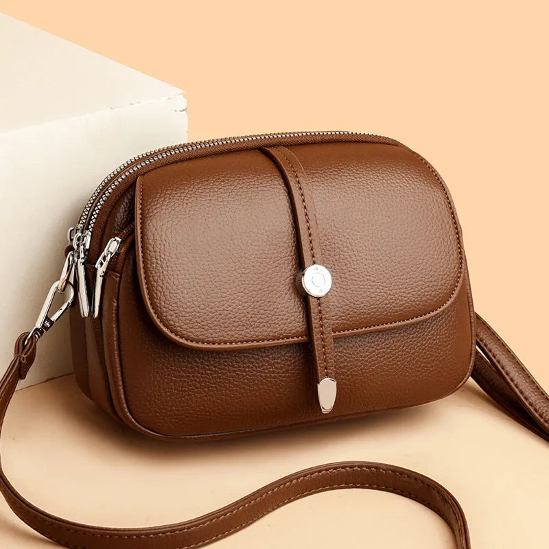 Soft PU oval-shaped women's crossbody shoulder bag in dark brown with sewing thread details.