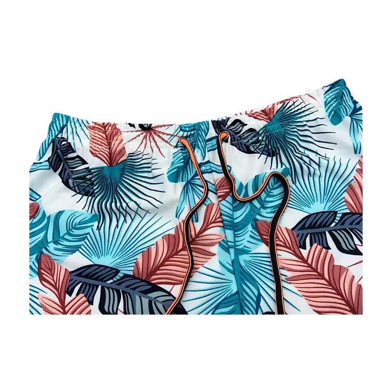 Men's cropped beach swimming trunks in a multicolour leaf pattern, briefs style