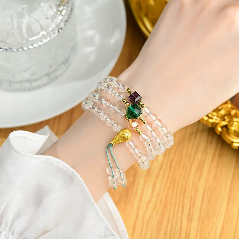 White crystal 108 bead geometric ethnic style bracelet necklace shown worn as both bracelet and necklace