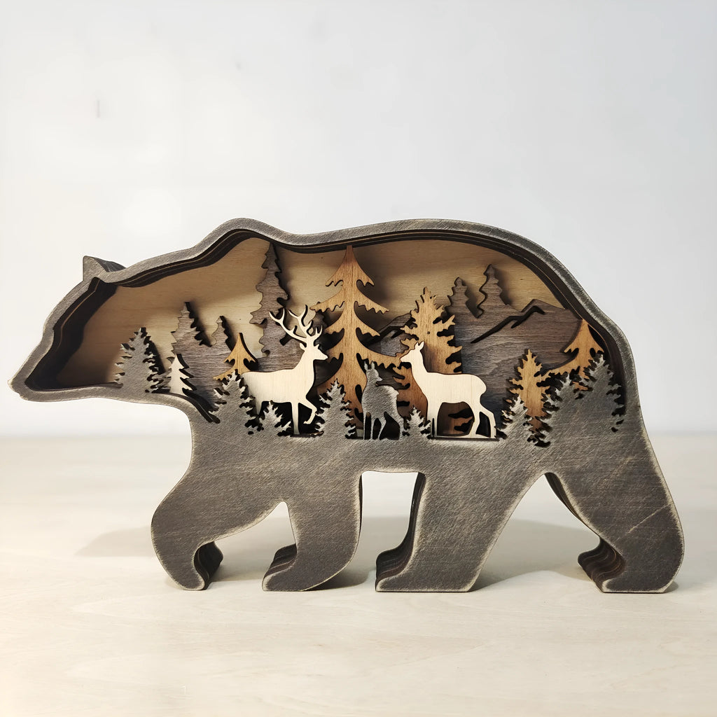 Two boxwood wooden ornaments, elk and brown bear, on a flat surface with natural wood finish