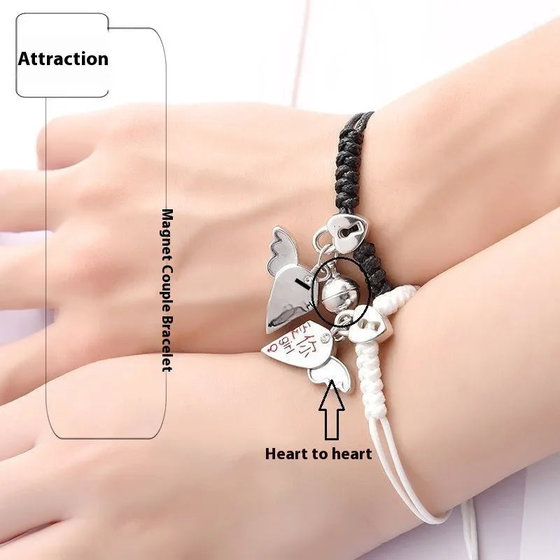 A pair of magnetic couple bracelets with alloy charms showing an I love you design and a key lock on a textured background.