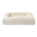 Beige rectangular cloth dog bed sofa nest for pets on a floor