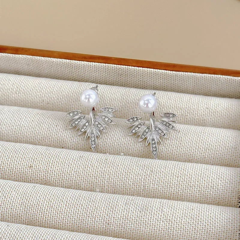 Silver ladies backward-hanging wing pearl earrings with diamond setting on alloy base