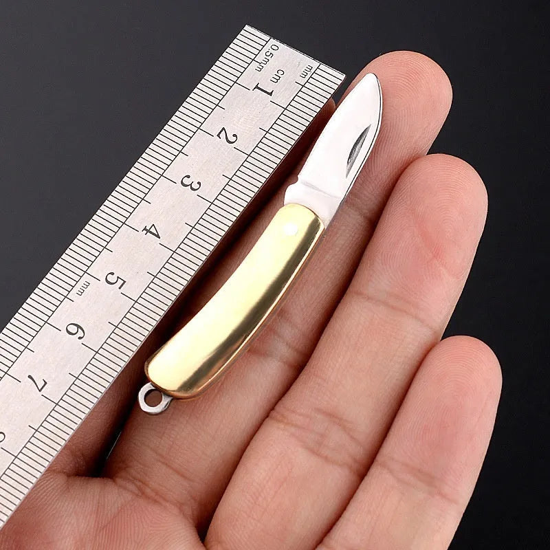 Brass mini folding knife keychain pendant with 3cm blade and 42mm shank on a key ring