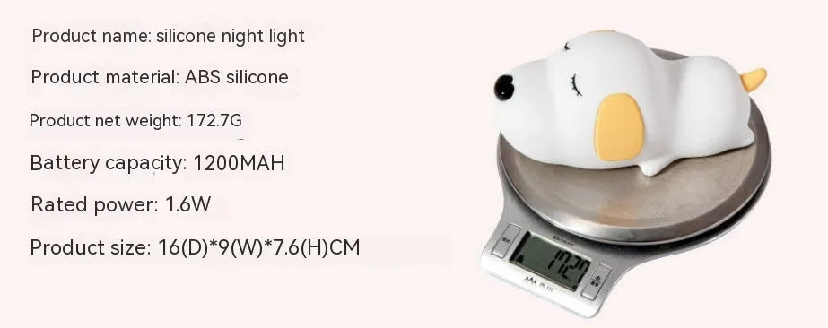 Small two-tone cartoon dog shaped silicone night lamp with USB charging port.