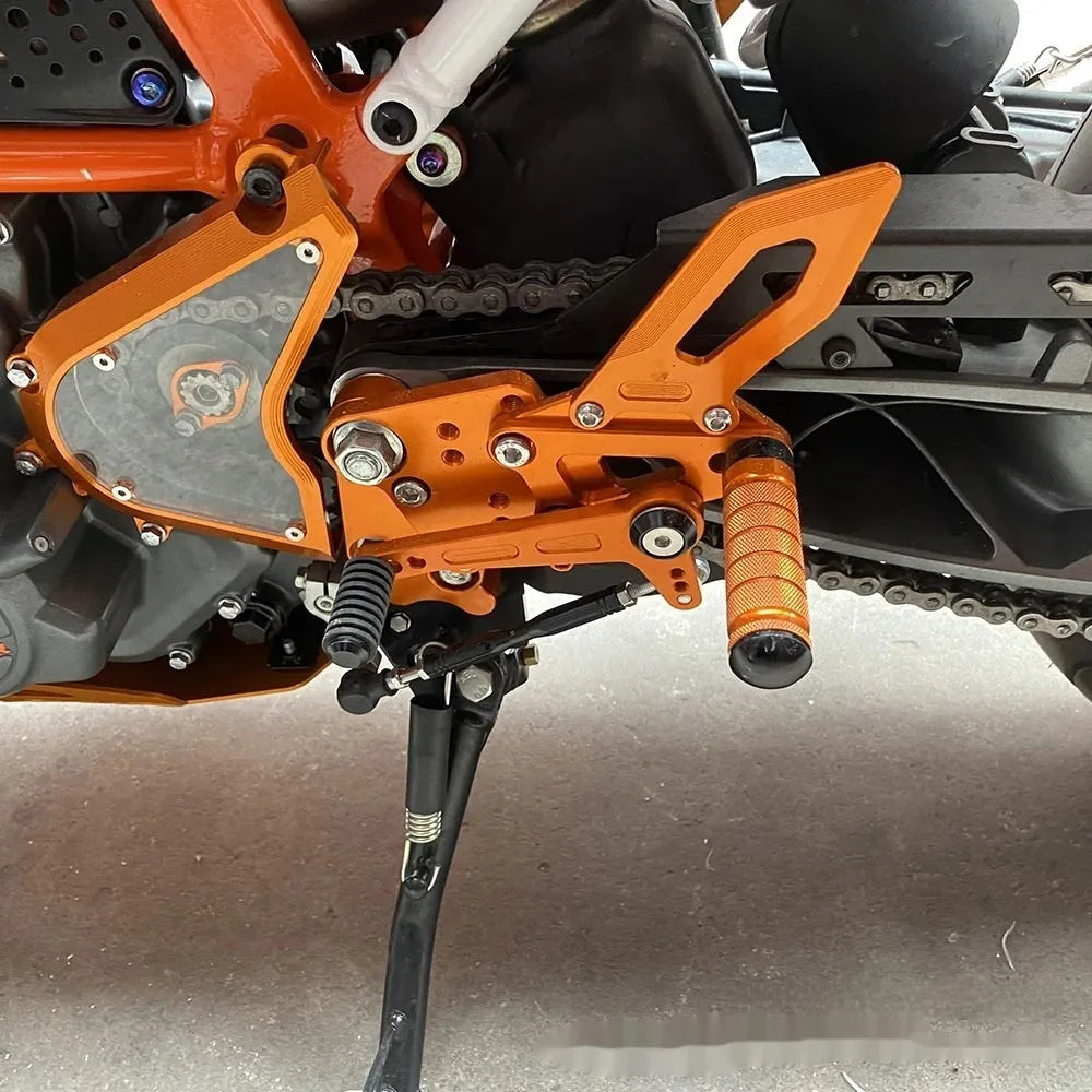 KTM Duke rear shift pedal support assembly bracket in black or orange for 125 200 250 390 models