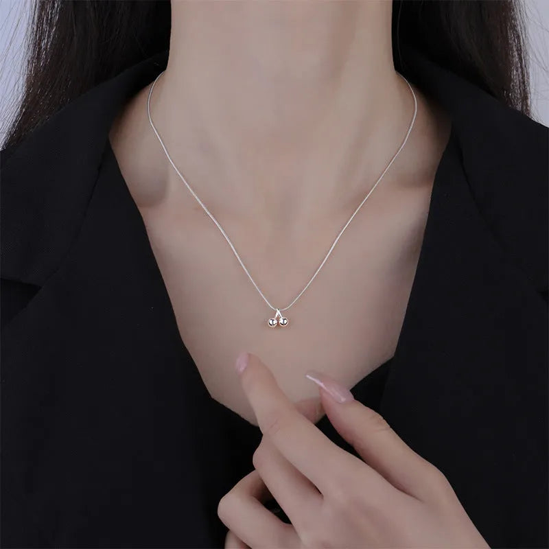 925 silver cherry pendant necklace with an adjustable snake bones chain on a white background.
