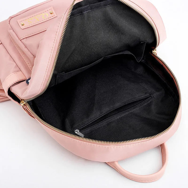 Black nylon women's casual backpack with internal pockets and double shoulder straps.