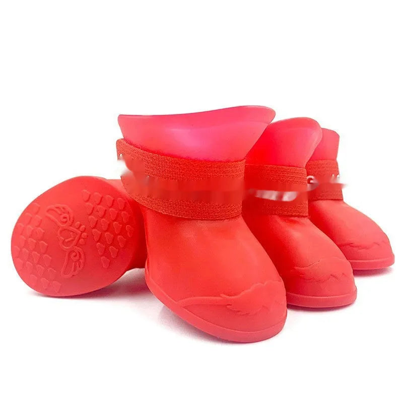 Set of four anti-slip pet rain shoes in various colours with rubber soles for waterproof dog paw protection.