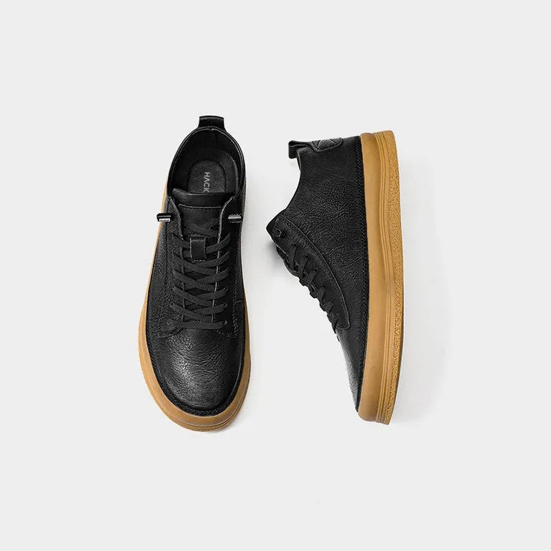 Men's black casual leather shoes with a round toe and lace-up front on a white background.