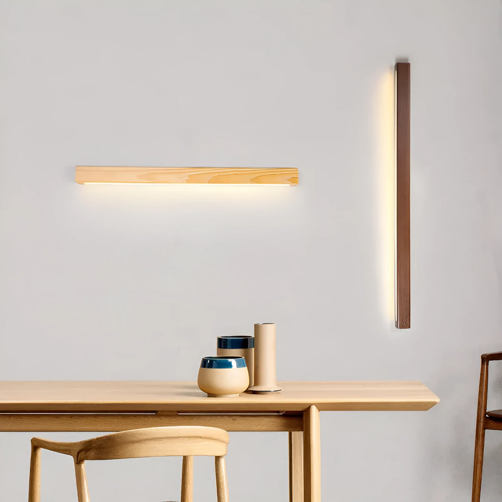 Modern Walnut wood and acrylic log strip wall lamp mounted on a wall in a living room setting.