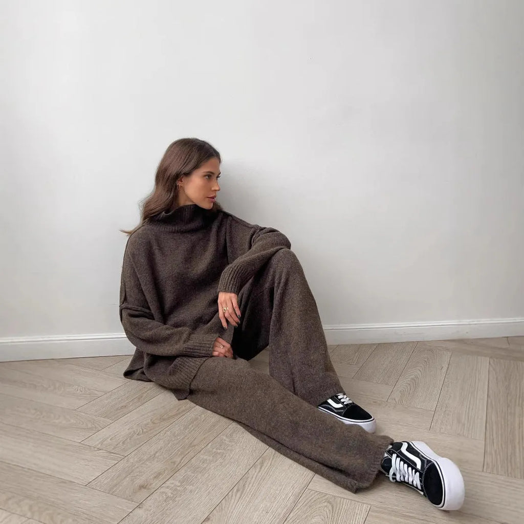 Women's solid colour acrylic sweater and trousers suit set with a side-slit top design.