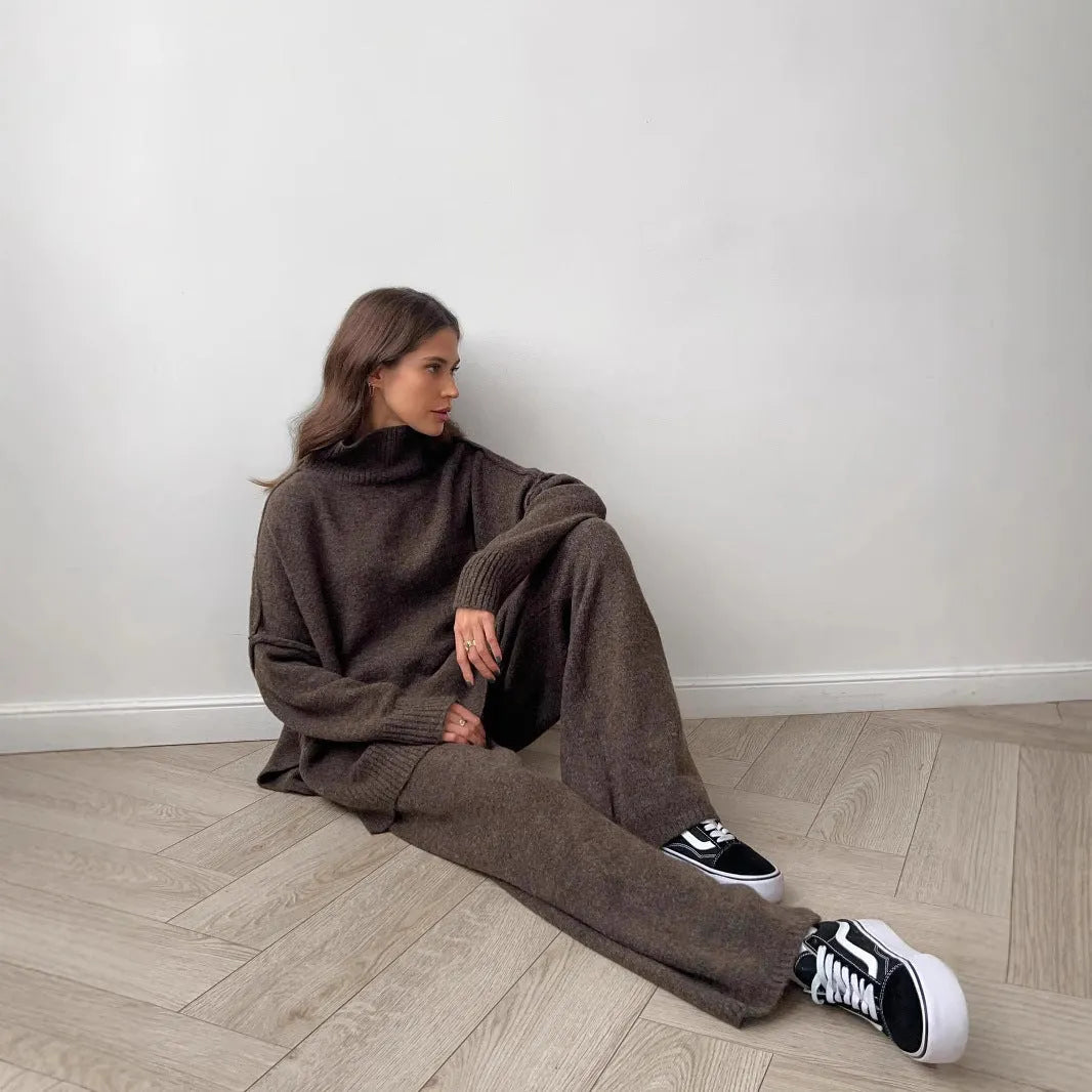 Women's solid colour acrylic sweater and trousers suit set with a side-slit top design.