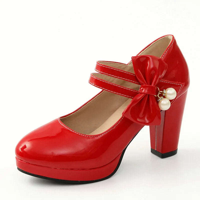 Women's red chunky heel platform shoes with round toe and buckle fastening on a rubber sole.