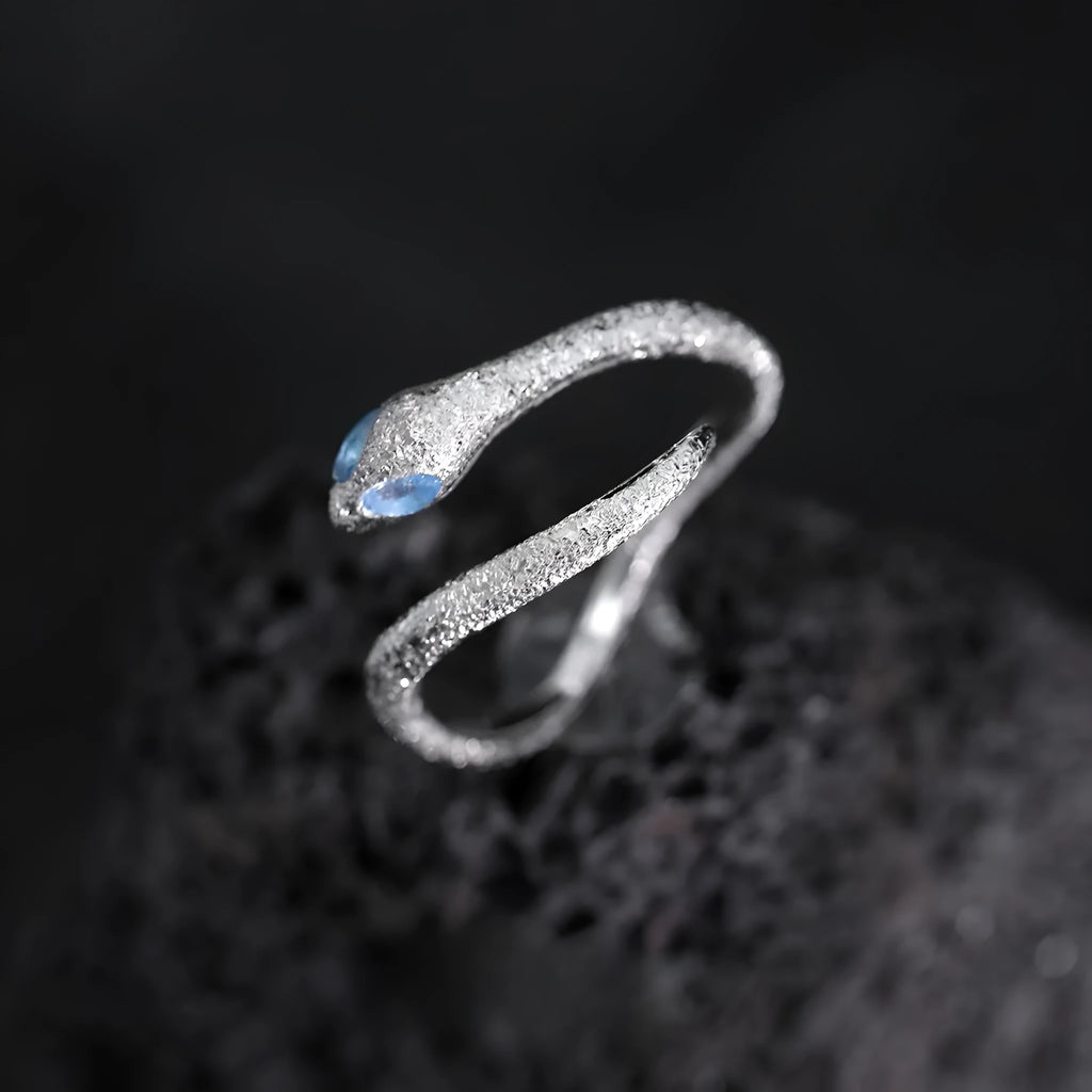 Adjustable silver snake ring with electroplated white gold finish and zodiac design
