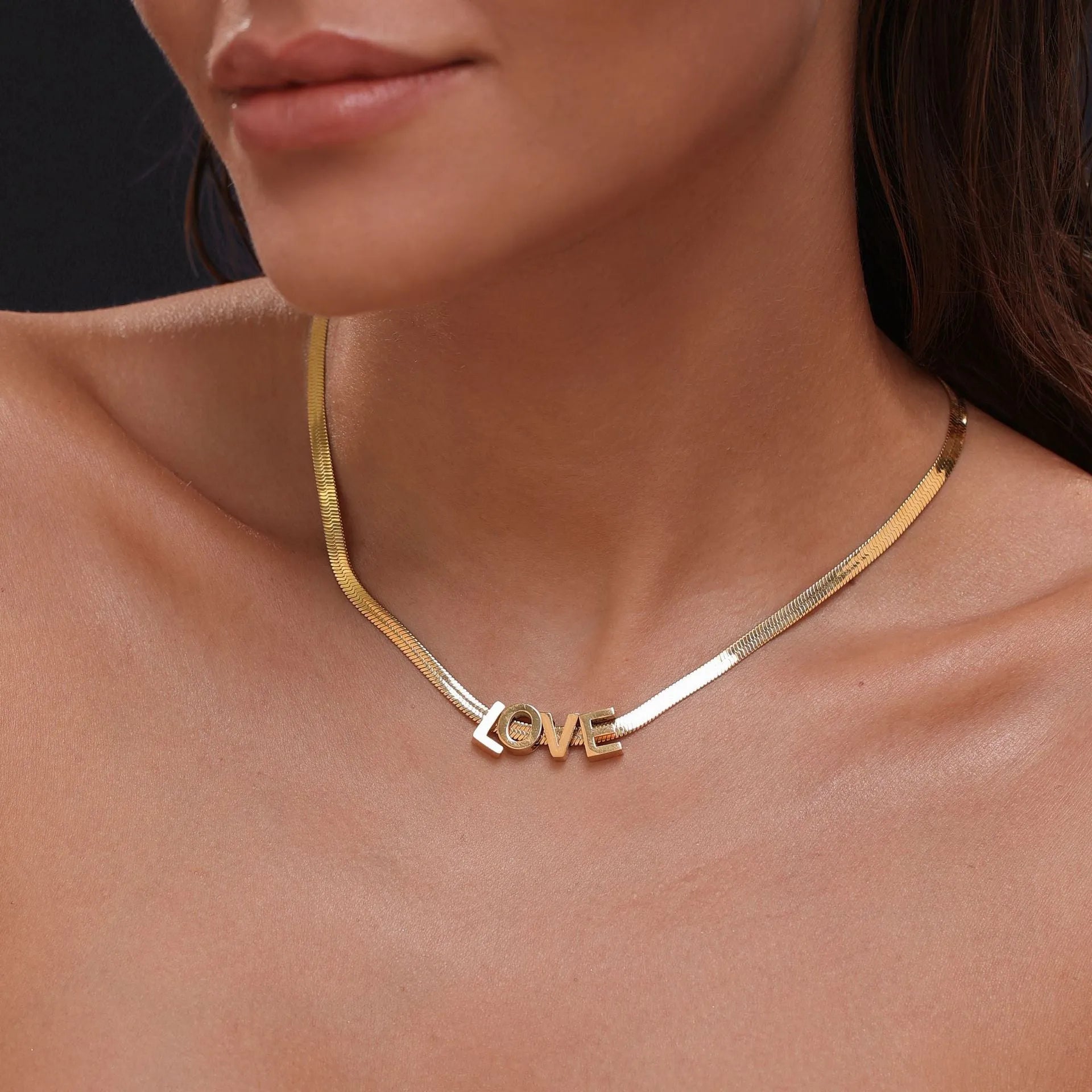 Gold electroplated titanium steel necklace with a single letter A pendant on a 40.5cm blade chain.