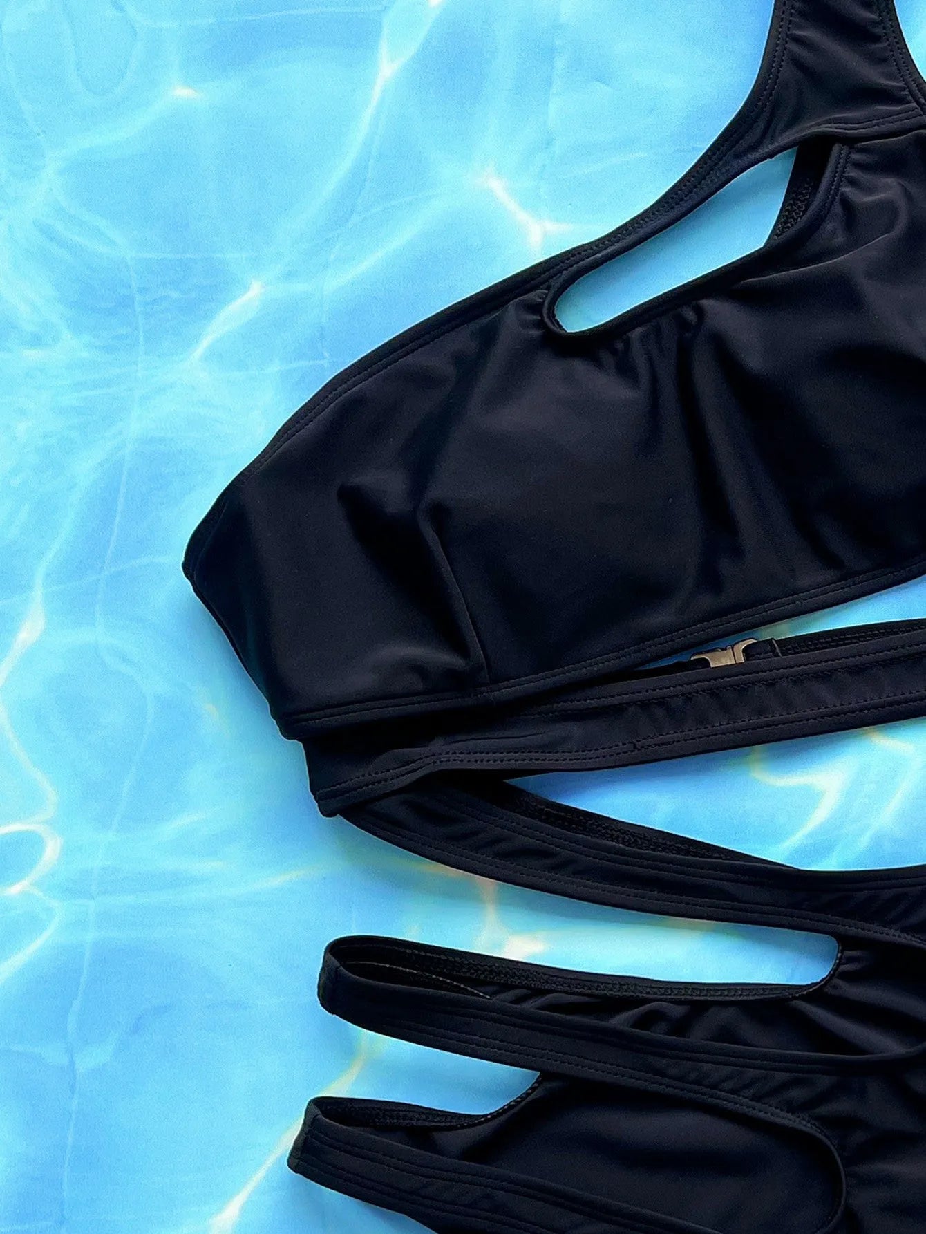 Black women's one-piece swimsuit with hollow-out strap design on the back.
