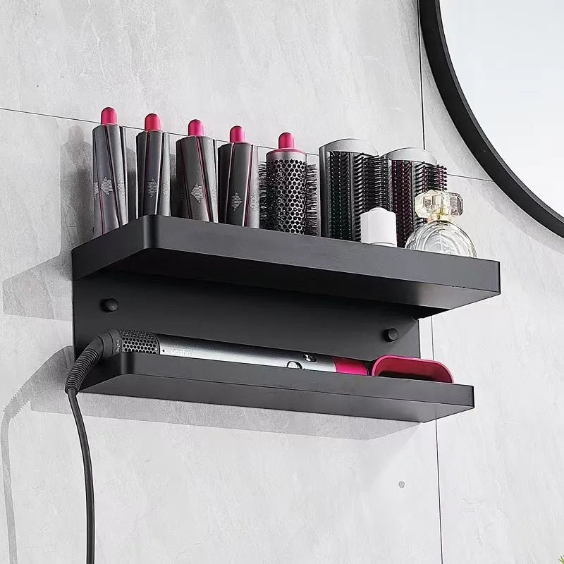 White double-layer aluminium wall rack holding hair curlers, mounted punch-free on a tiled bathroom wall.