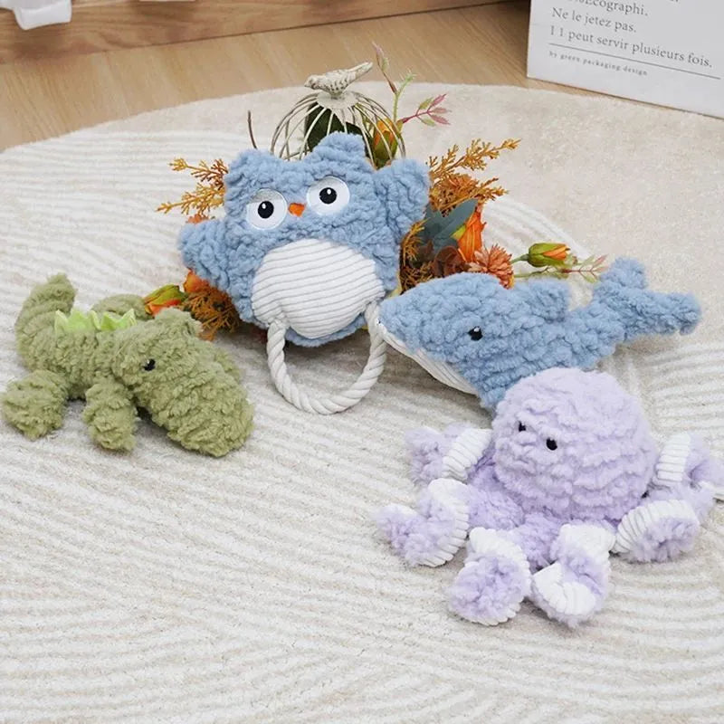 Plush corduroy caterpillar fabric dog toy in shark shape with squeaker on white background
