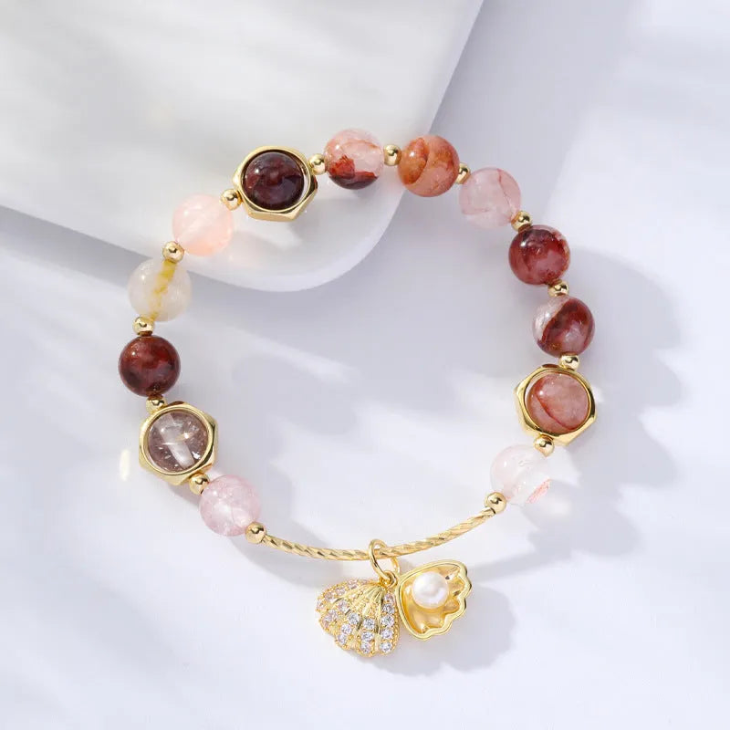 Women's crystal bracelet with coloured hair crystal shells and red sealant flower shells on wrist