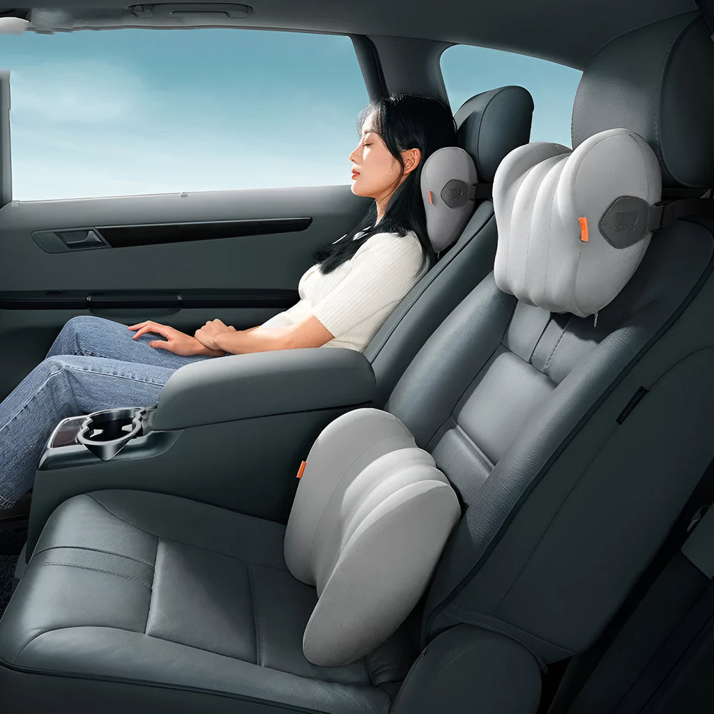 Grey and orange memory foam car headrest and lumbar support pillow set on a car seat.
