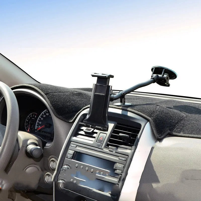 Black universal car tablet holder with suction cup mounted on a dashboard, holding an iPad.