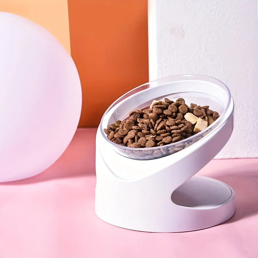 White elevated cat food bowl with a tilted surface on a raised platform.
