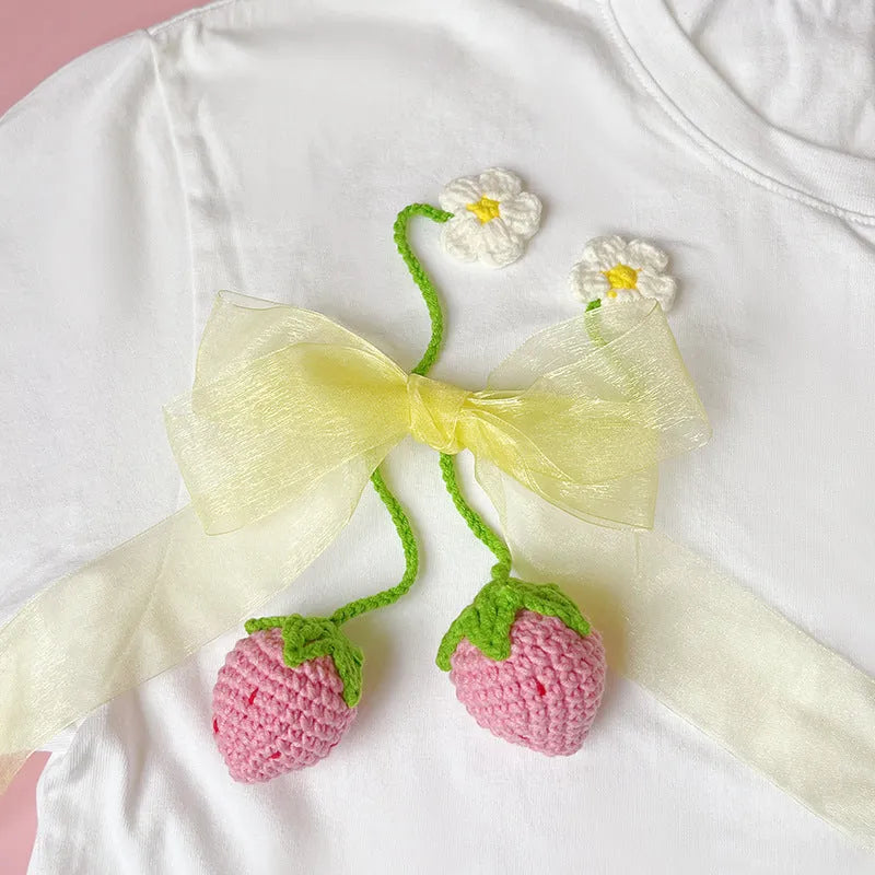 Wool crochet strawberry pendant necklace with woven design measuring 35cm in pink or red colour