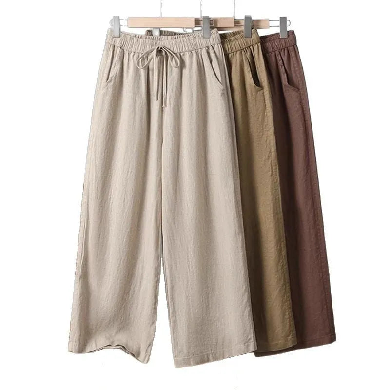 Women's apricot straight-leg casual trousers with elastic waist and front drawstring detail.
