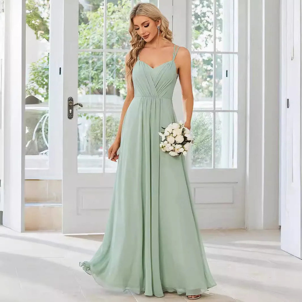Sleeveless long pleated A-line women's dress in light green polyester fabric, shown on a model.