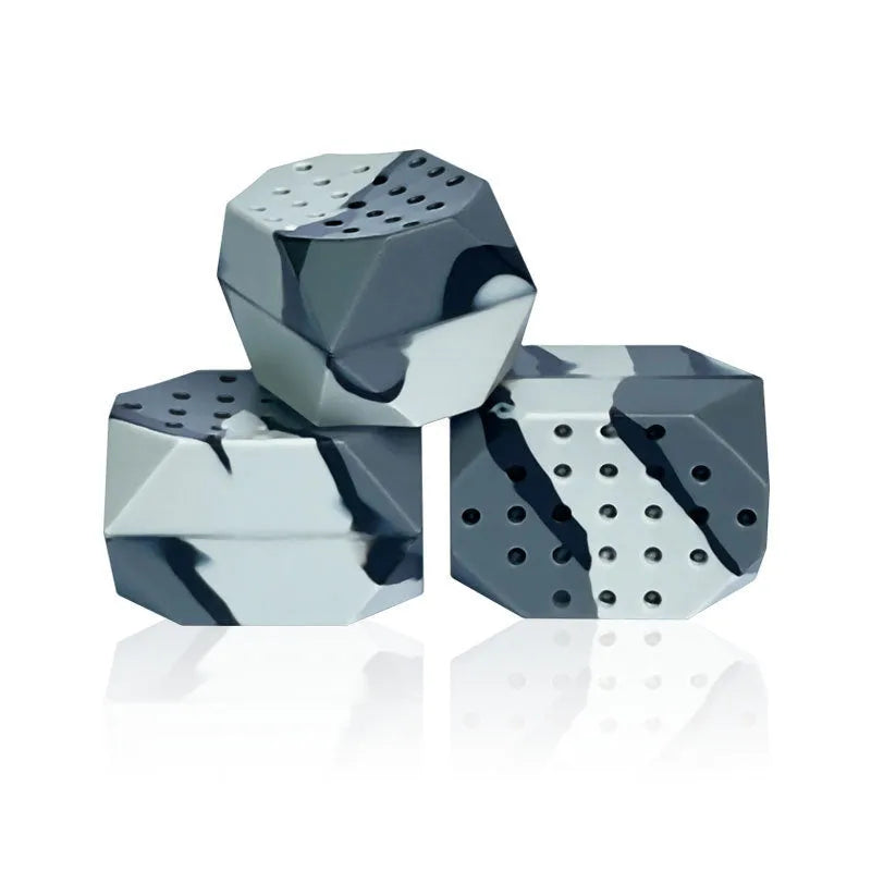 Two camouflage silicone facial muscle fitness balls for jaw training in a transparent box.