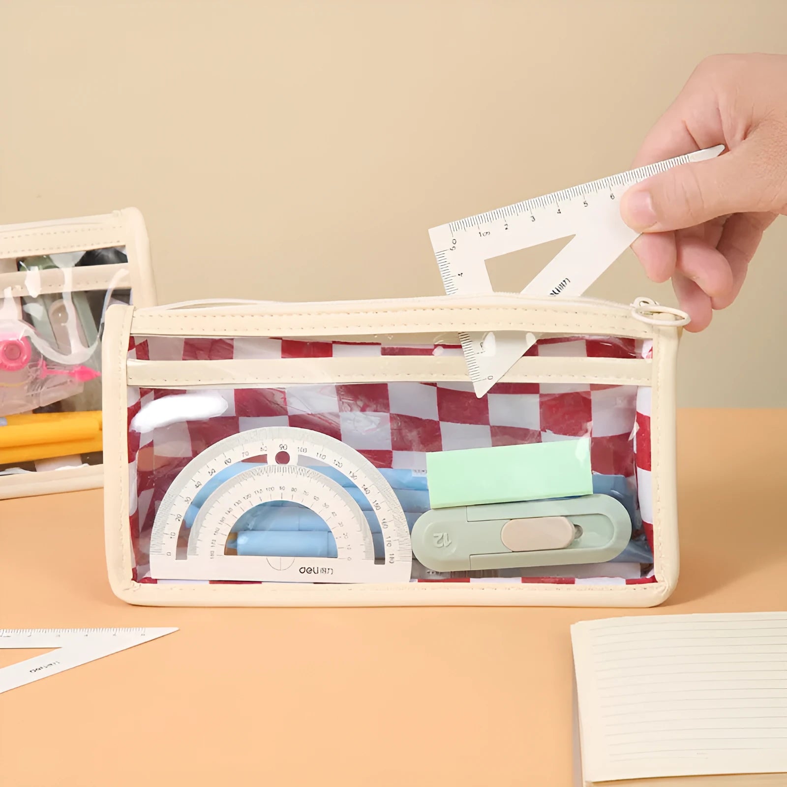 Transparent PVC pencil case with chessboard grid pattern in black and white or red and white.