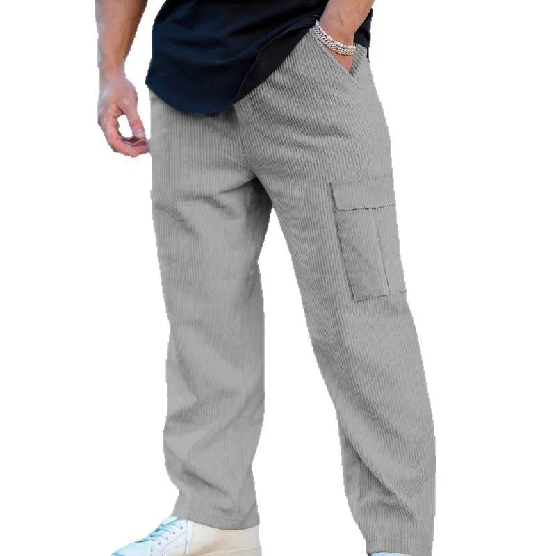Men's loose-fitting corduroy cargo trousers in navy blue with a drawstring waist and straight wide legs.
