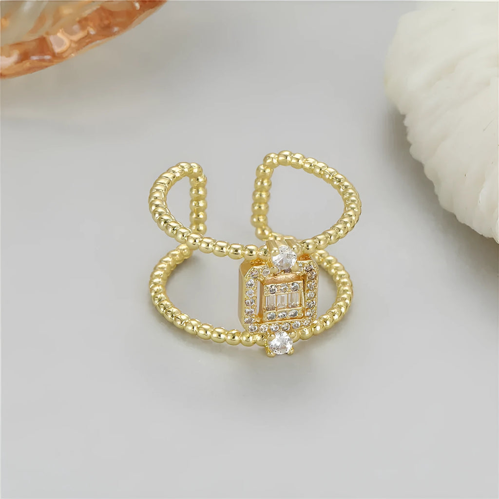 Copper open ring with gold plating and adjustable U-shaped design on a finger.