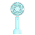 Blue handheld mini USB fan with 3-speed buttons on a desktop.