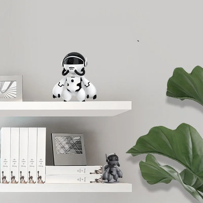 White or black wireless household security camera on a detachable base with a wide-angle lens.