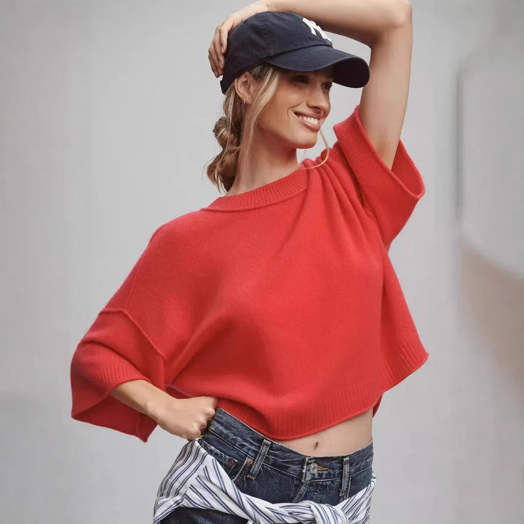 Red cropped t-shirt with exposed navel design and short sleeves on mannequin