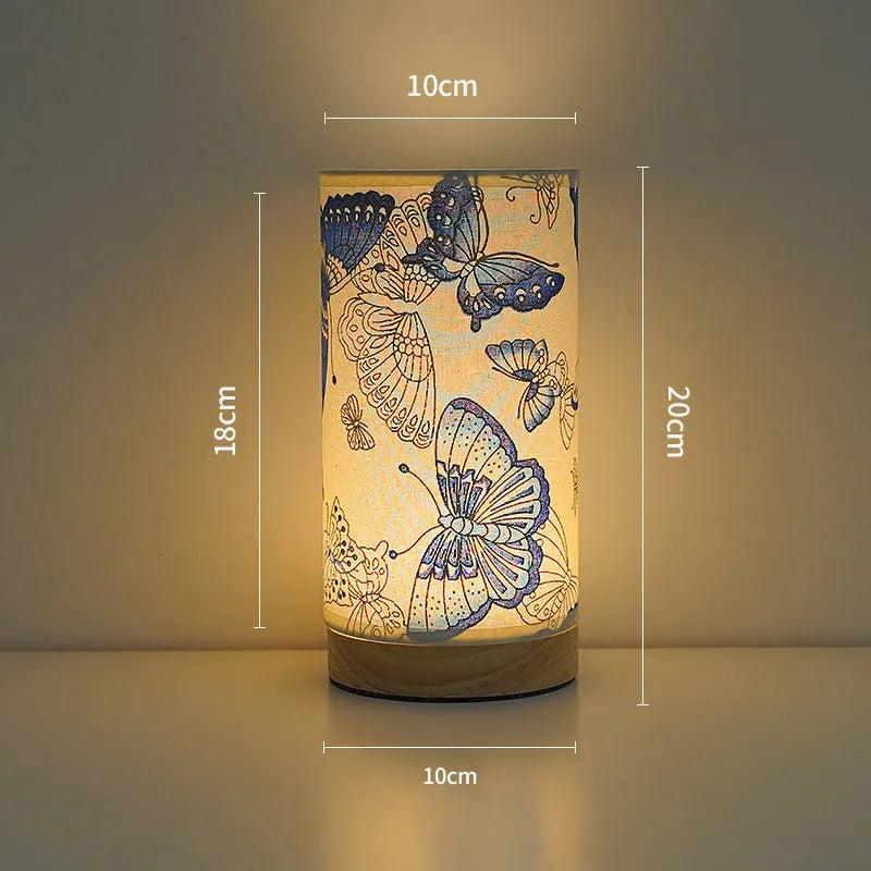 Creative USB table lamp with fabric shade in blue butterfly pattern on modern desk