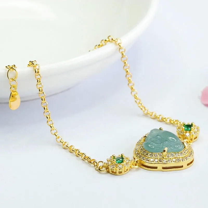 Close-up of a blue jade Maitreya Buddha pendant on a women's bracelet.