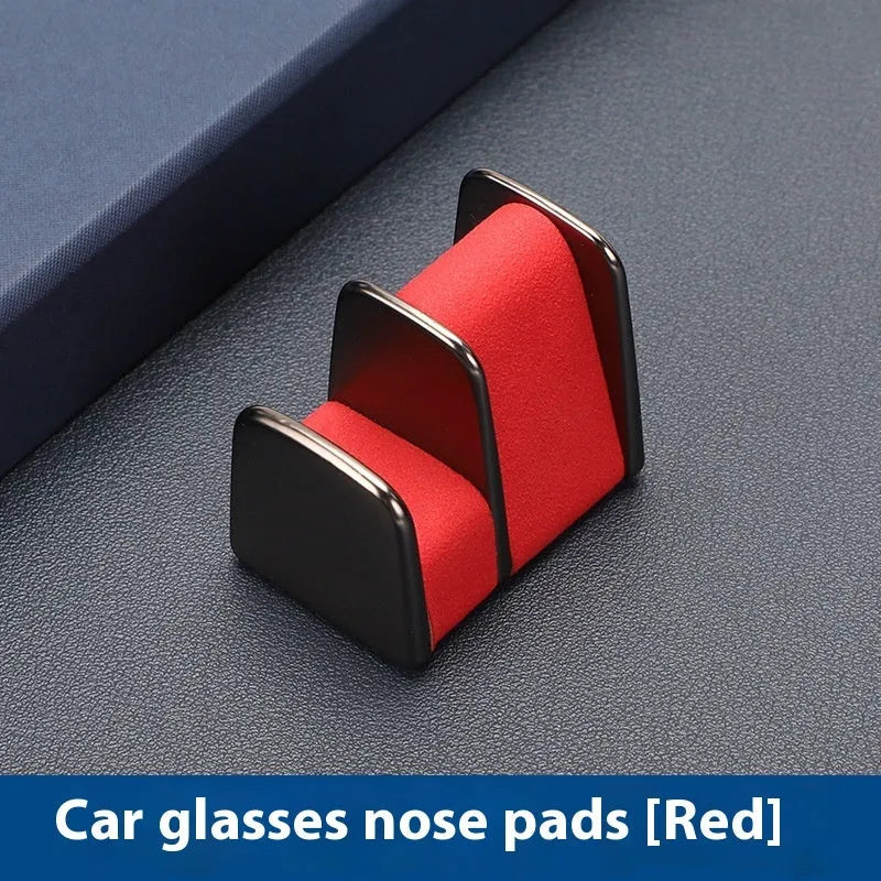 Zinc alloy and leather glasses clip for car dashboard in black, grey, green, or red.