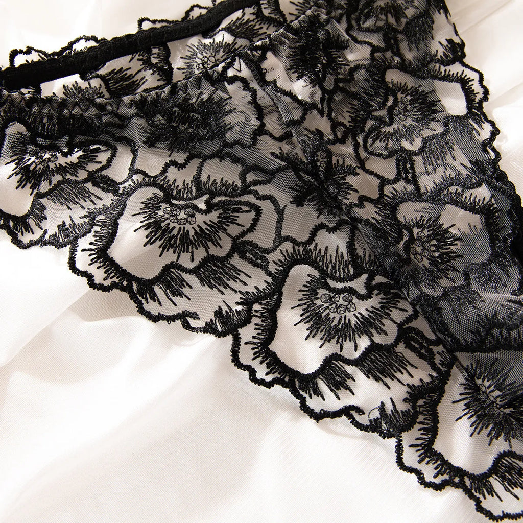 Black women's embroidered lace underwear with steel ring decorative detail on sheer polyester fabric