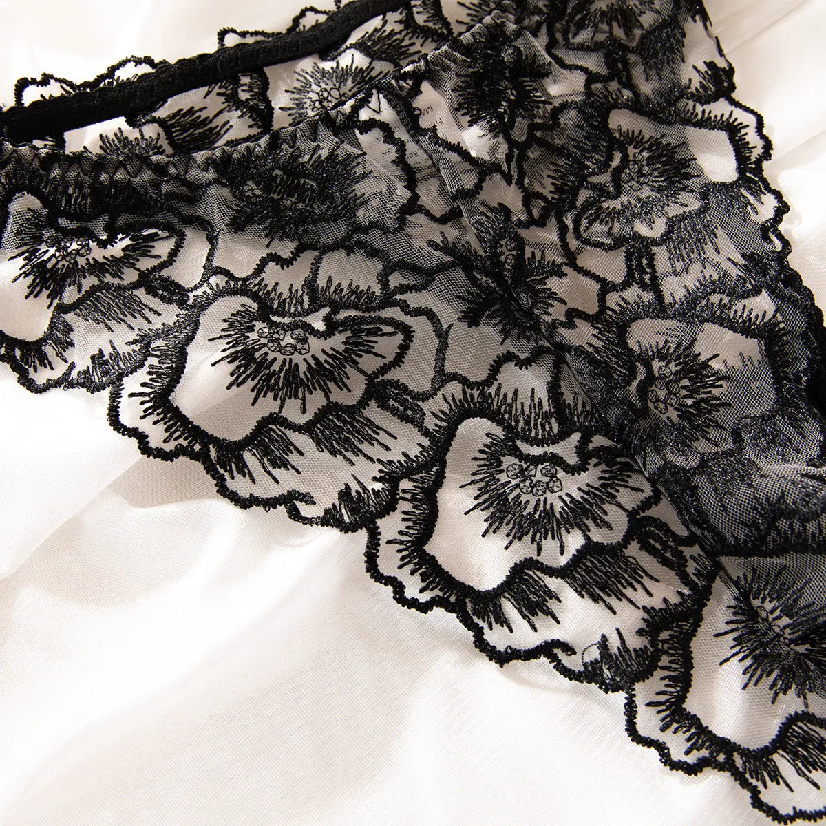 Black women's embroidered lace underwear with steel ring decorative detail on sheer polyester fabric