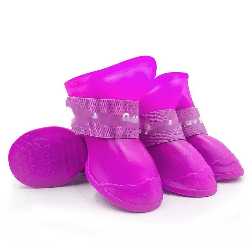 Set of four anti-slip pet rain shoes in various colours with rubber soles for waterproof dog paw protection.