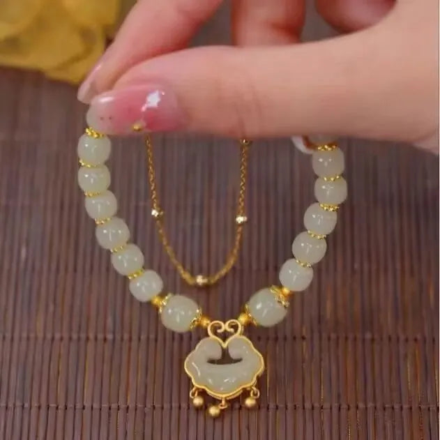 Green women's bracelet with traditional Chinese xiangyun lock pendant and safety closure