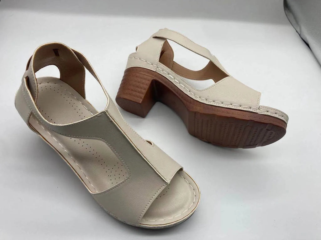 Womens beige Roman style wedge sandals with open peep toe and silver buckle strap on a low heel.