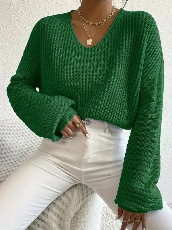 Woman wearing a solid colour long sleeve loose fit casual polyester pullover.