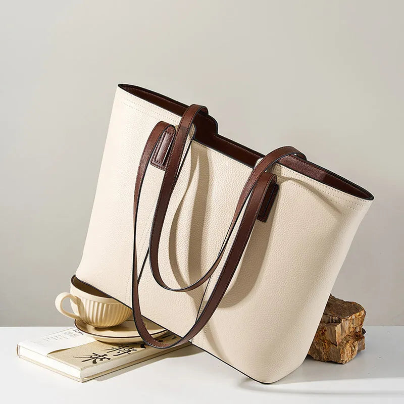 Women's black genuine leather crossbody bag showing horizontal square shape and internal organiser pockets